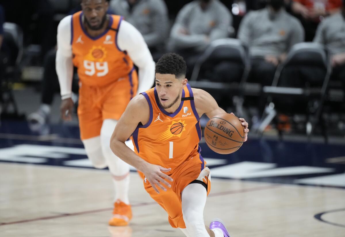 Phoenix Suns guard Devin Booker picks up the ball in the first half of Game 3 at Denver on June 11, 2021.