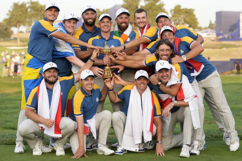 Europe's Team Captain Luke Donald , centre, and team members lift the Ryder Cup after winning the trophy by defeating the United States 16/12 point to 11 1/2 points at the Marco Simone Golf Club in Guidonia Montecelio, Italy, Sunday, Oct. 1, 2023. (AP Photo/Alessandra Tarantino)