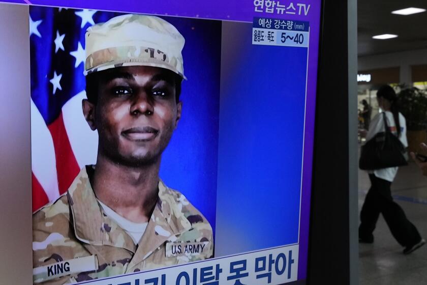A TV screen shows a file image of American soldier Travis King during a news program at the Seoul Railway Station in Seoul, South Korea, Monday, July 24, 2023. The deputy commander of the U.N. Command said Monday it has started conversations with North Korea over King who ran into the North last week across the Koreas' heavily armed border. (AP Photo/Ahn Young-joon)