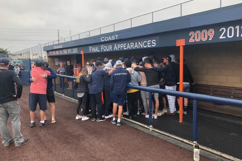 Shot was taken out at the Orange Coast College baseball field. Coach John Altobelli and daughter xxx died in same copter crash that killed Kobe Bryant. John's brother, Tony, is wearing an orange shirt and hugging outside the dugout at the OCC field this afternoon.