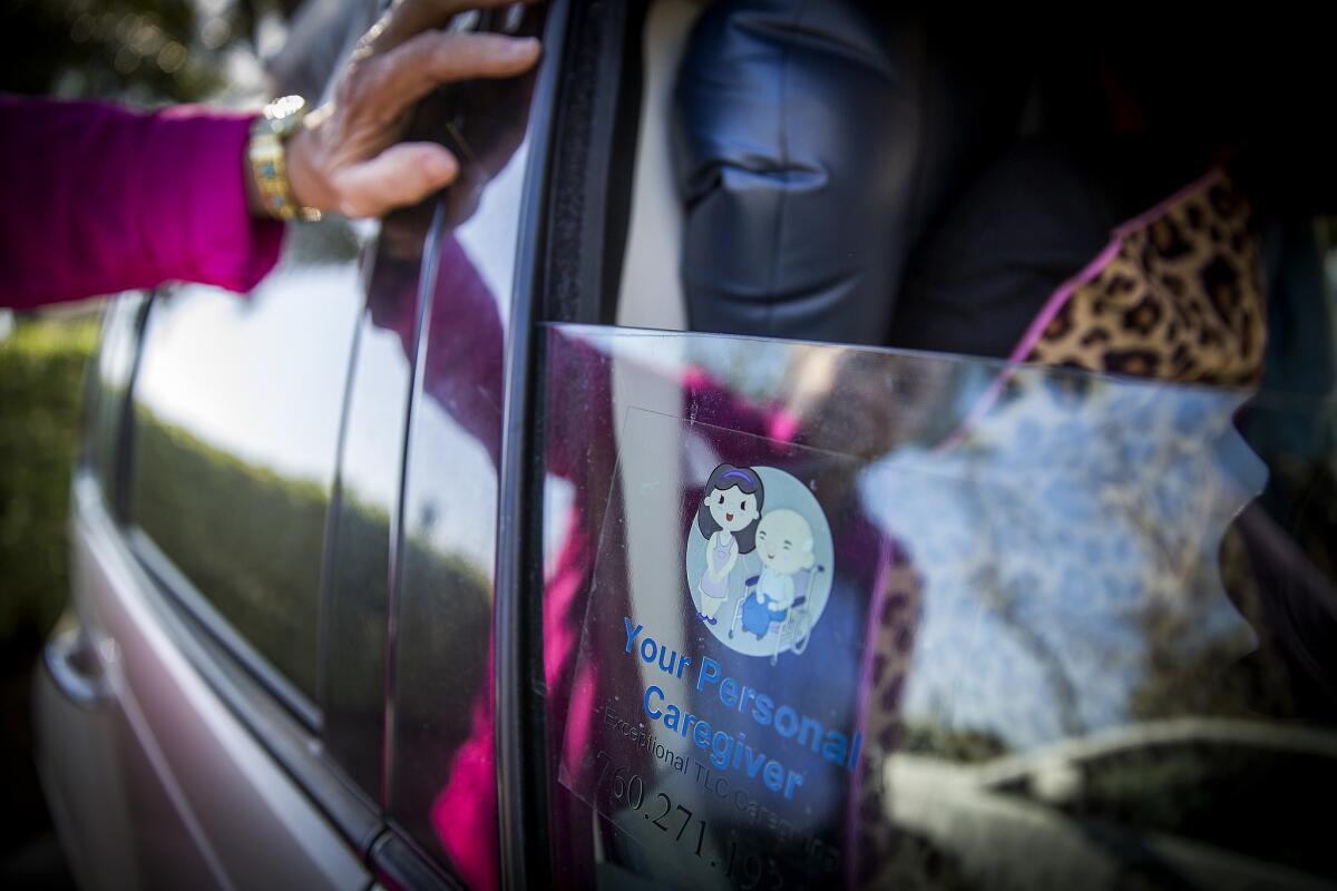 A sticker adorns Russell's window from her last job as a personal caregiver.