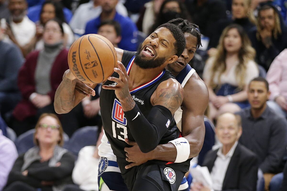 Los Angeles Clippers guard Paul George (13) is fouled by Minnesota Timberwolves forward Anthony Edwards during the second quarter during an NBA basketball game Tuesday, April 12, 2022, in Minneapolis. (AP Photo/Andy Clayton-King)