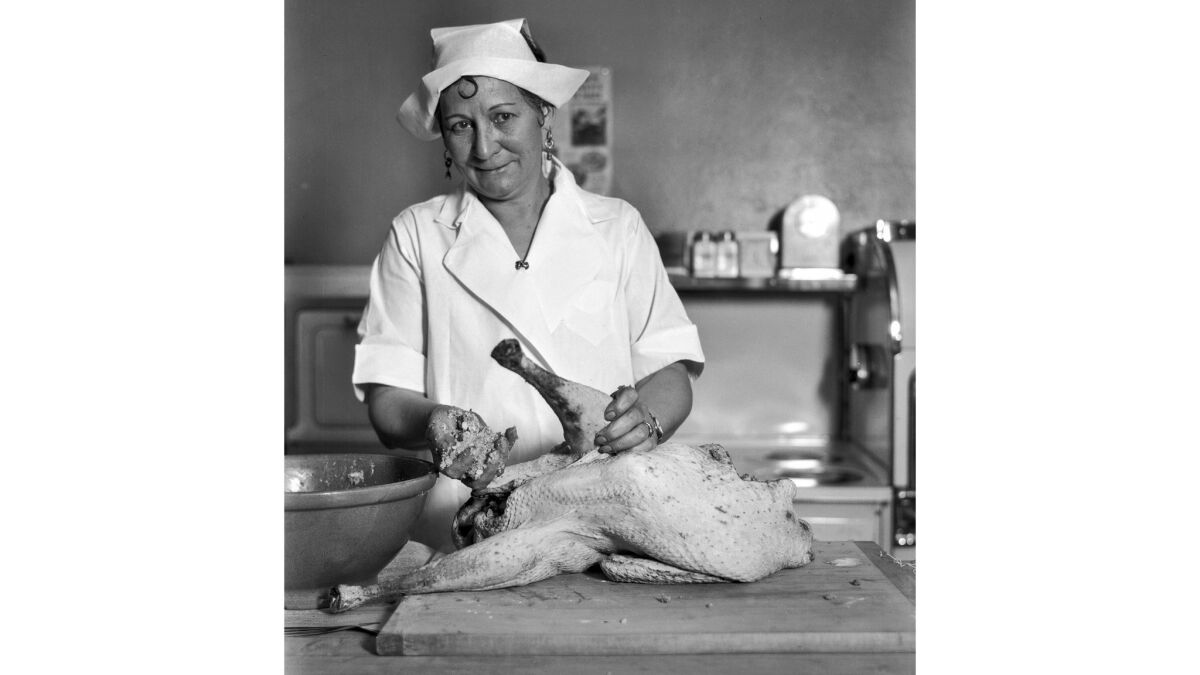 November 1928: Chef Mabelle Wyman stuffing a turkey for her Thanksgiving column.
