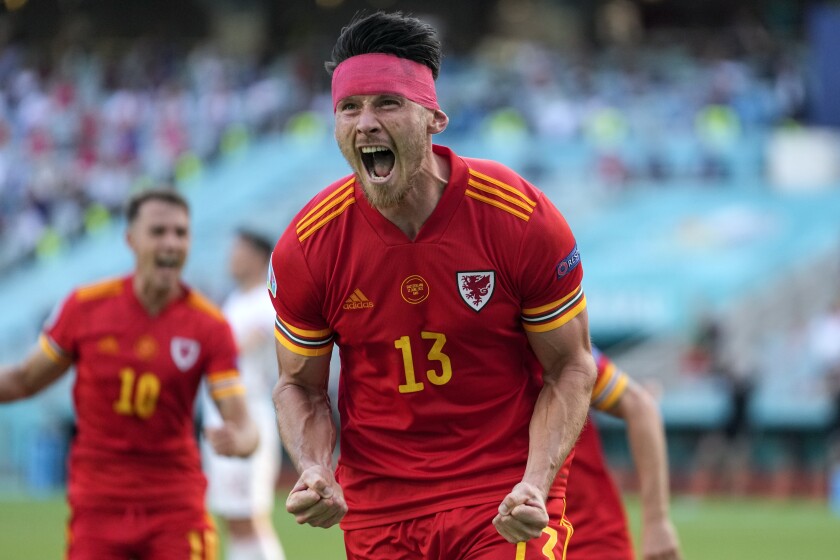 Wales' Kieffer Moore celebrates after scoring his side's opening goal during the Euro 2020 soccer championship group A match between Wales and Switzerland, at the Baku Olympic stadium, in Baku, Azerbaijan, Saturday, June 12, 2021. (AP Photo/Darko Vojinovic, Pool)
