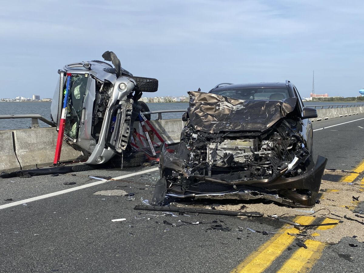 This photo provided by the Ocean City Fire Department shows the wreckage from a car accident on the Route 90 bridge in Ocean City, Md., on Sunday, May 2, 2021. A bystander jumped over a highway guard rail and into a Maryland bay Sunday to rescue a child who had been thrown from a car and into the water during the crash, according to authorities. The child was ejected from a car on the Route 90 bridge in Ocean City and landed in the Assawoman Bay, the Ocean City Fire Department said in a statement. At least eight people were injured in total, the agency said. (Ocean City Fire Department via AP)