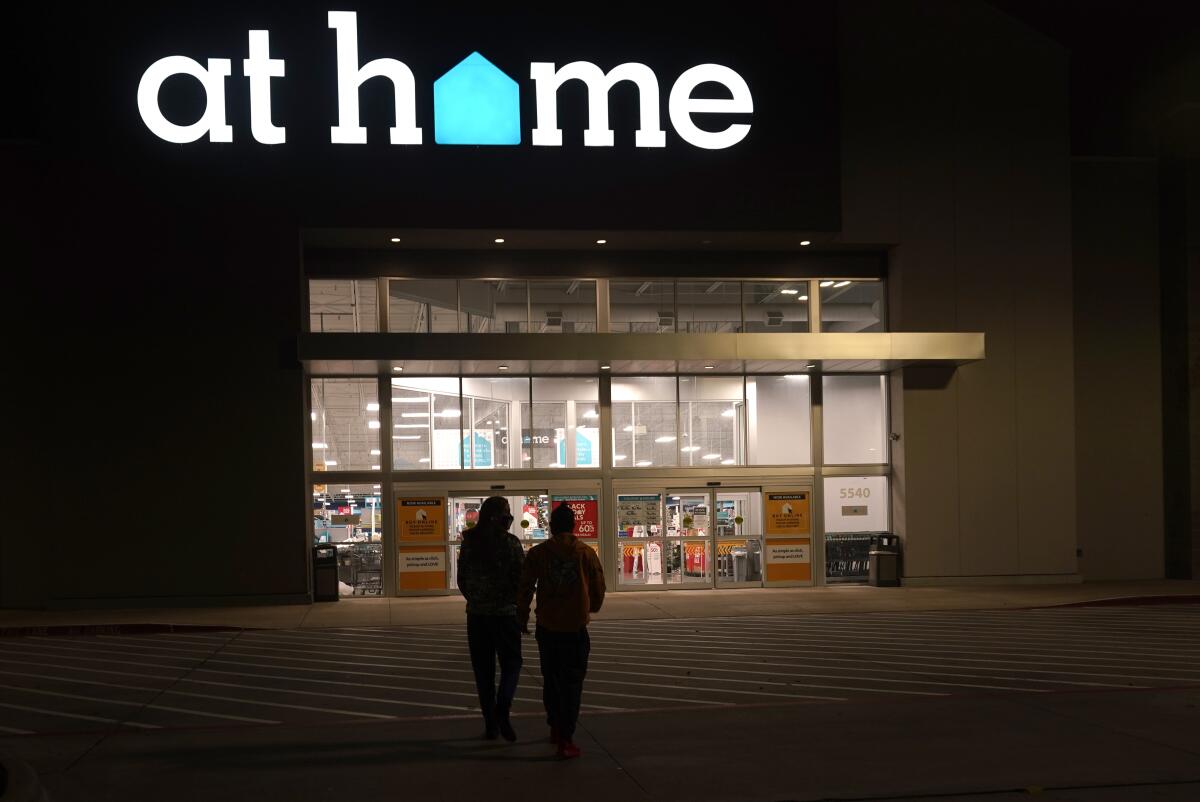 Shoppers walk up to an At Home store.