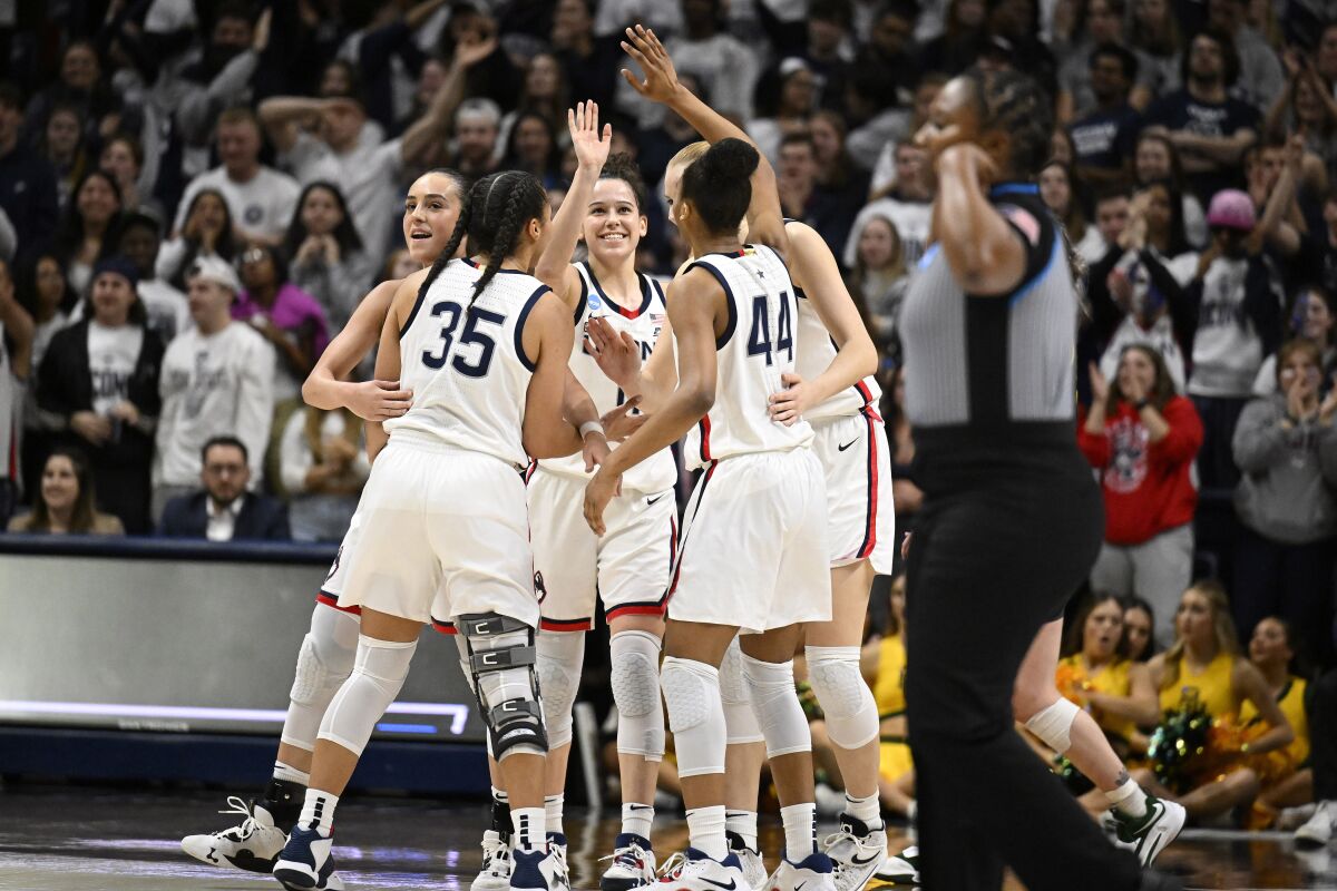UConn players celebrate in the second half of a second-round college basketball game against Baylor in the NCAA Tournament, Monday, March 20, 2023, in Storrs, Conn. (AP Photo/Jessica Hill)