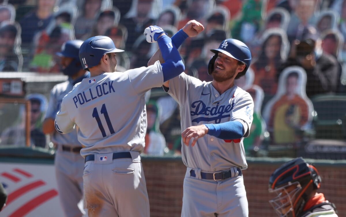 Dodgers' A.J. Pollock is congratulated by Cody Bellinger.
