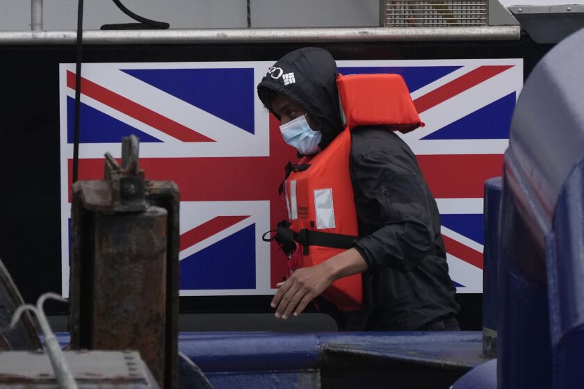 FILE - A man thought to be a migrant who made the crossing from France disembarks after being picked up in the Channel by a British border force vessel in Dover, south east England, Friday, Aug. 13, 2021. The British government pushed its contentious migration bill forward in Parliament on Monday, March 27, 2023 even as Europe’s top human rights organization urged lawmakers to block the legislation. (AP Photo/Matt Dunham, File)