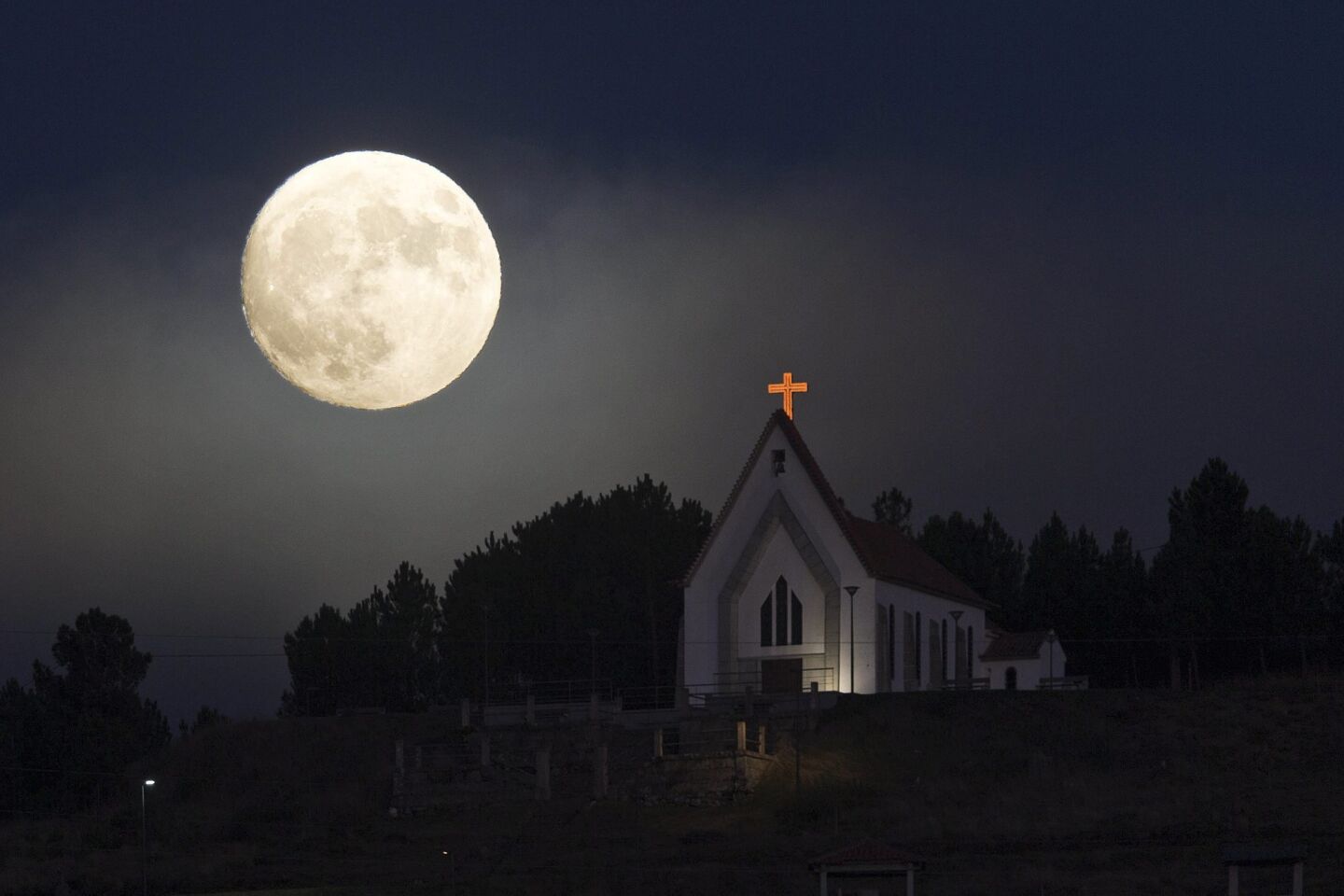 View of the church of Our Lady of Conception, with the moon during the brighter full moon phenomenon, when the moon will be closest to the earth since the past 70 years, in Vila Pouca de Aguiar, Northern of Portugal.