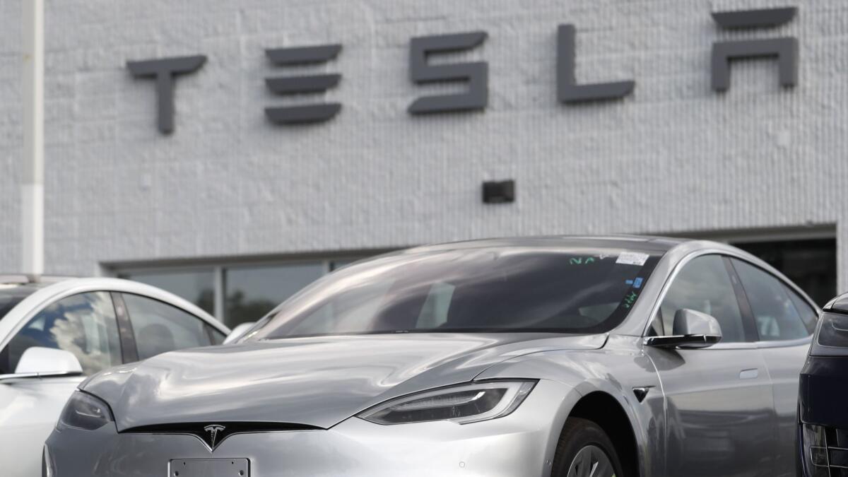 Tesla Model 3 sedans sit on display outside a company showroom in Littleton, Colo., in July.