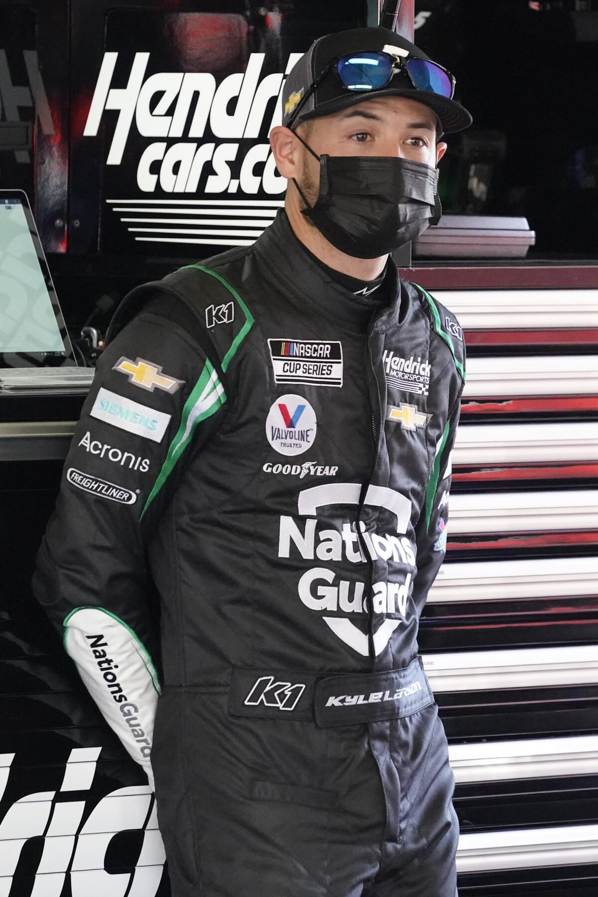 Kyle Larson stands in his garage during a NASCAR Daytona 500 auto race practice session at Daytona International Speedway, Wednesday, Feb. 10, 2021, in Daytona Beach, Fla. (AP Photo/John Raoux)