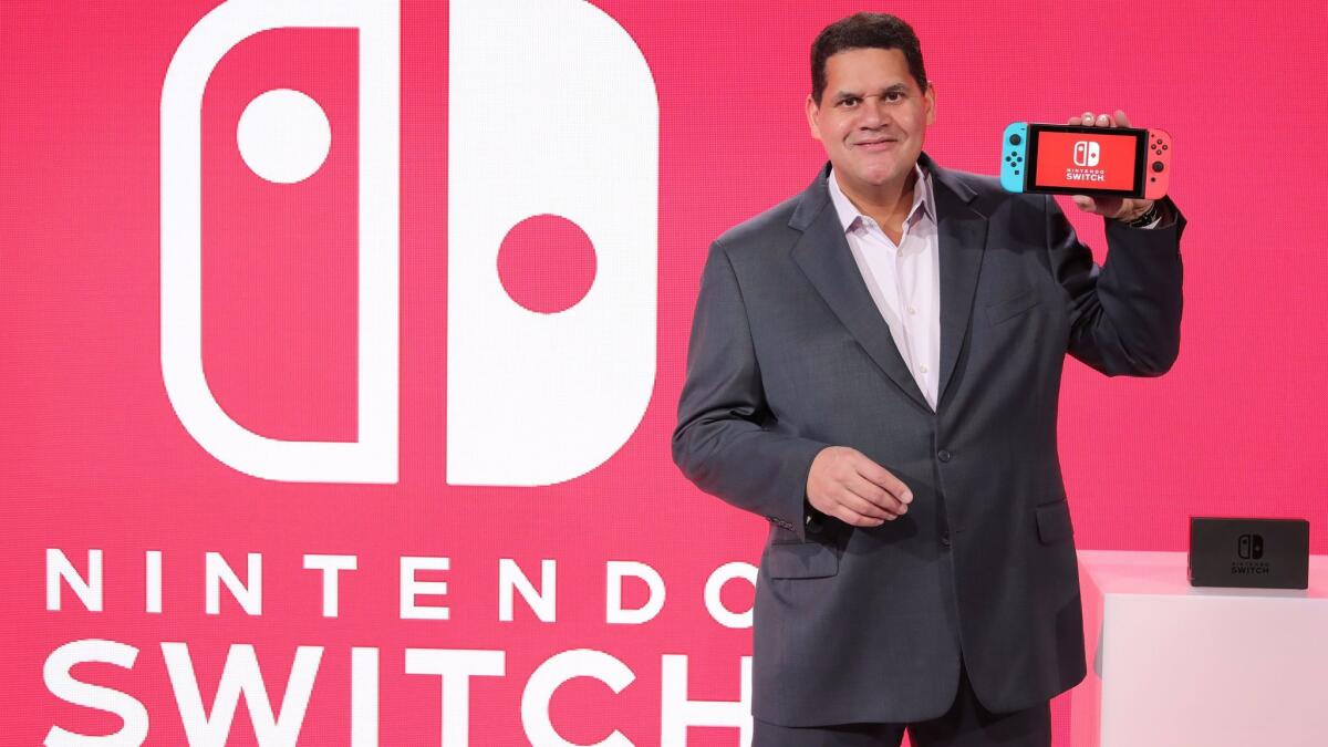 Nintendo of America President Reggie Fils-Aimé showcases the Switch, in handheld mode, at a Nintendo press event.