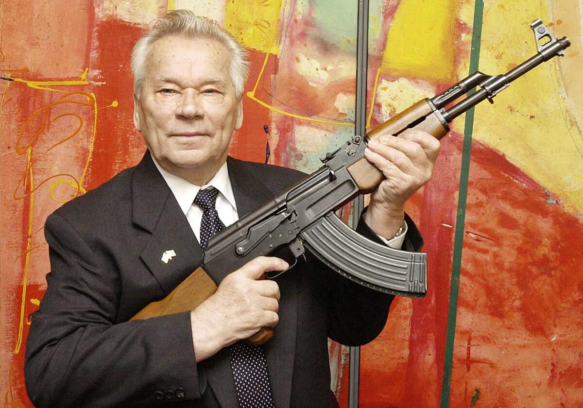 Mikhail Kalashnikov with his legendary assault rifle at a weapons museum in Suhl, Germany, in 2002.