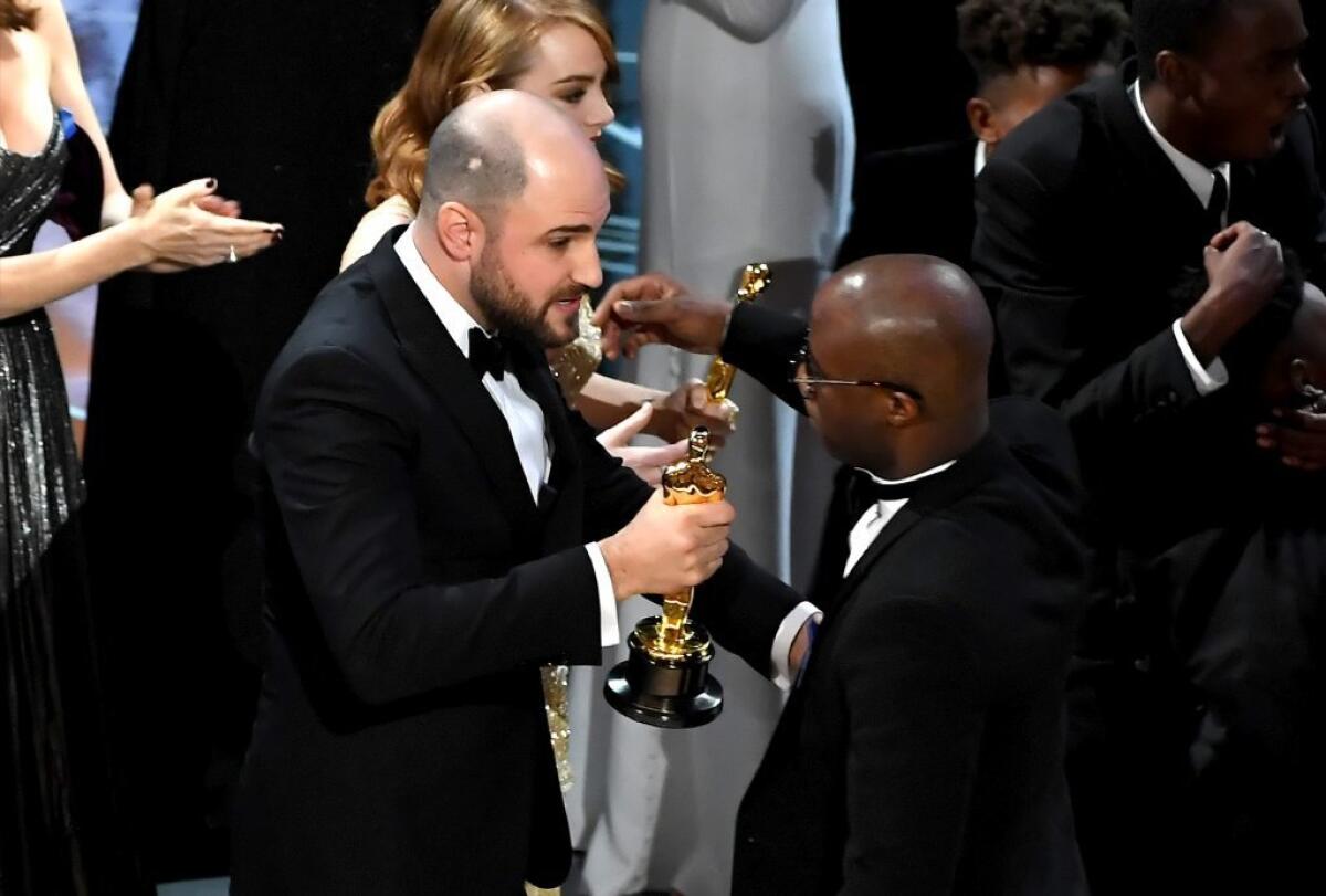 "La La Land" producer Jordan Horowitz hands the best picture Oscar to "Moonlight" filmmaker Barry Jenkins.