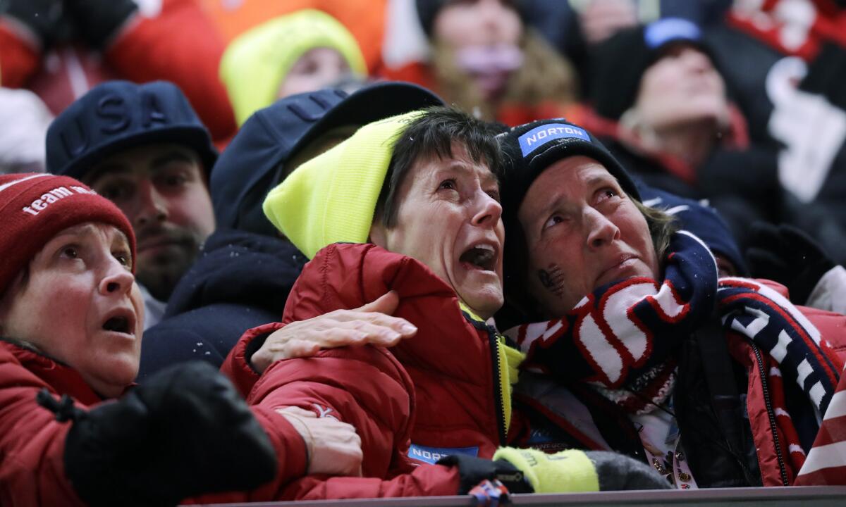 Sue Sweeney, center, Emily Sweeney's mother, cries out as her daughter crashes on the final run during the women's luge final Tuesday.