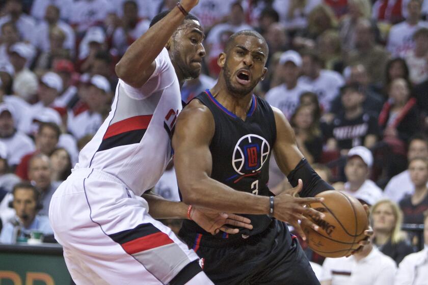 Clippers guard Chris Paul, right, drives to the basket past Portland Trail Blazers forward Maurice Harkless during the first half of Game 3 of the Western Conference first-round playoffs on April 23.
