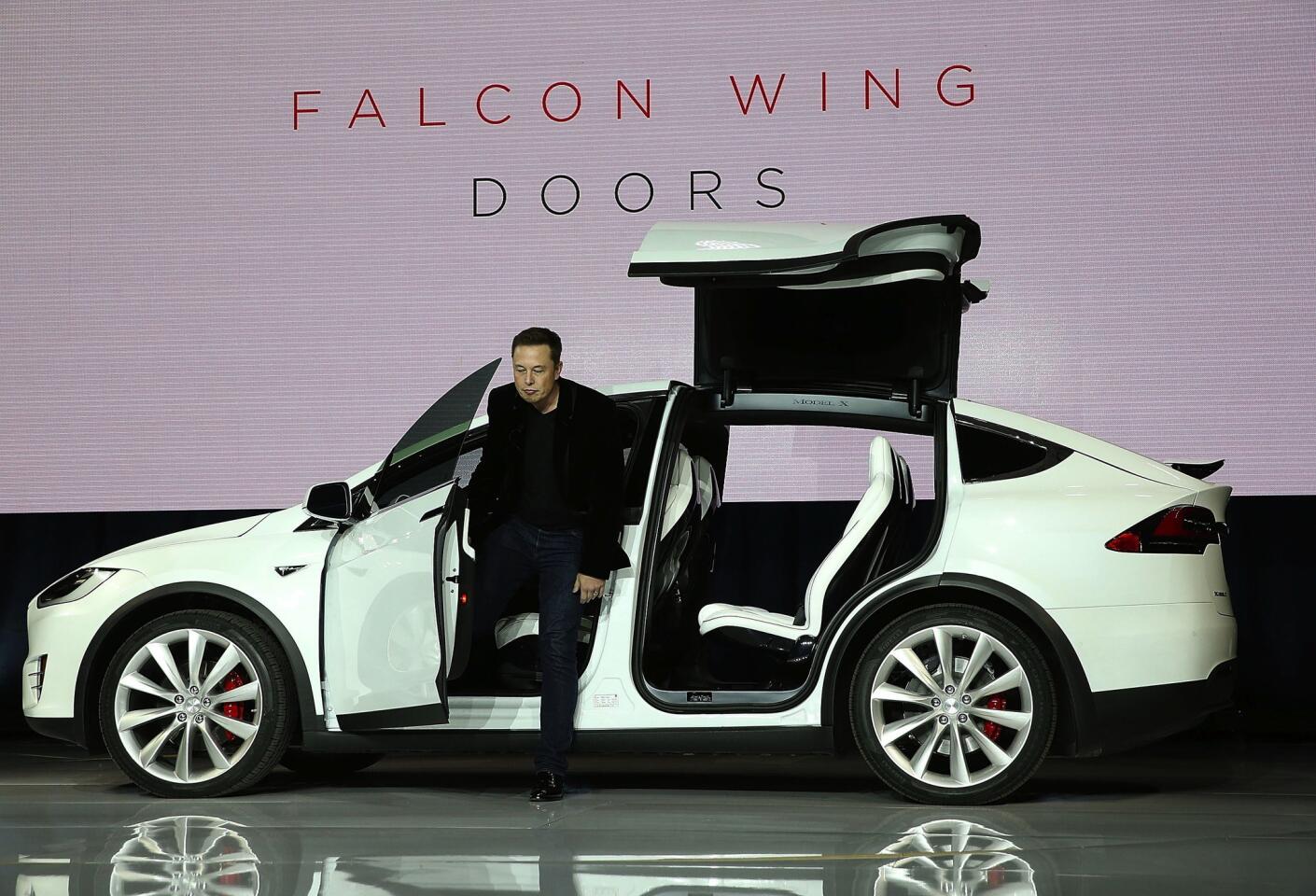 Tesla CEO Elon Musk demonstrates the falcon wing doors on the new Tesla Model X Crossover SUV during a launch event on September 29, 2015 in Fremont, California. After several production delays, Elon Musk officially launched the much anticipated all-electric Tesla Model X all-wheel-drive SUV. Read the first drive overview>>>