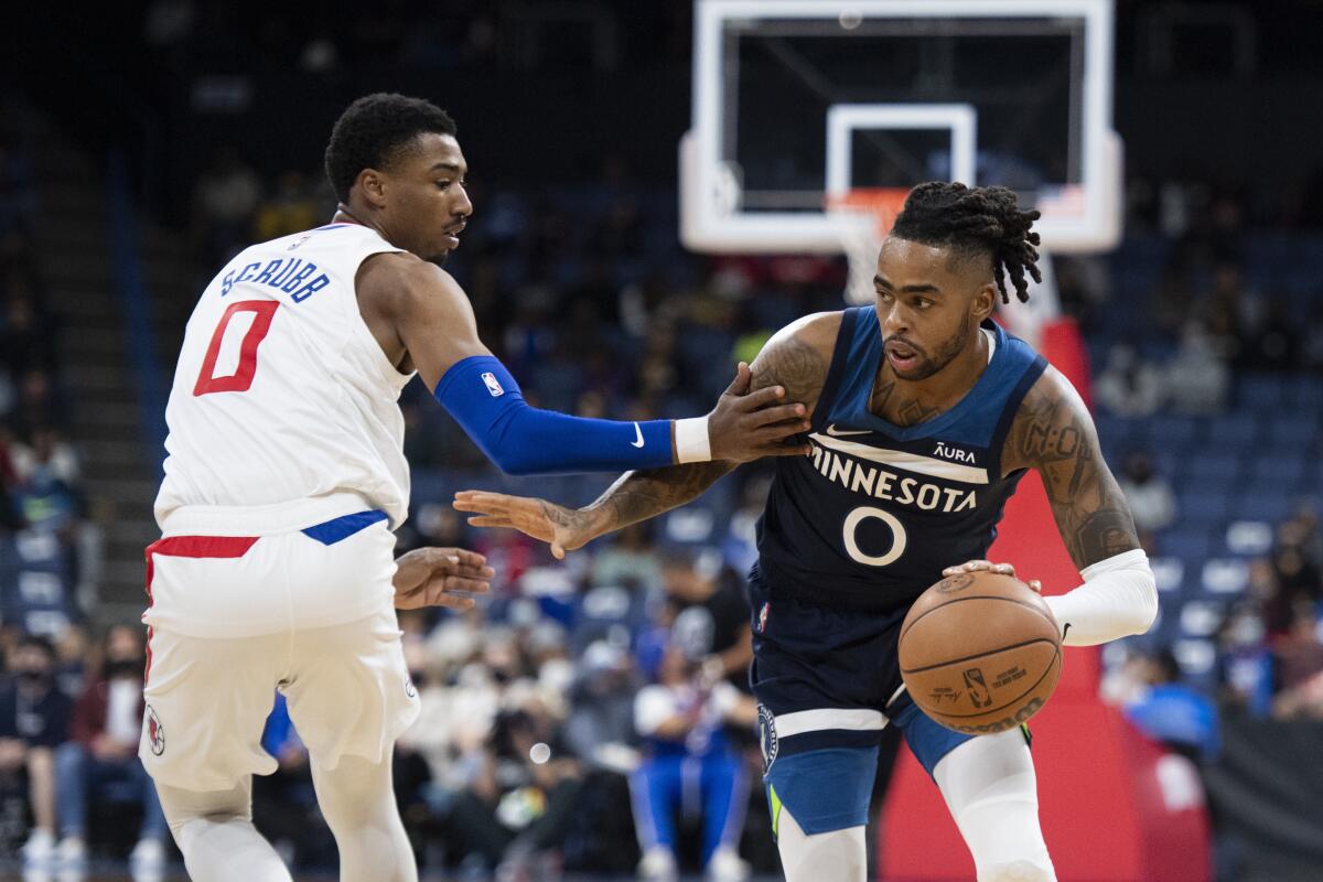 Minnesota Timberwolves guard D'Angelo Russell drives toward the basket past Clippers guard Jay Scrubb.