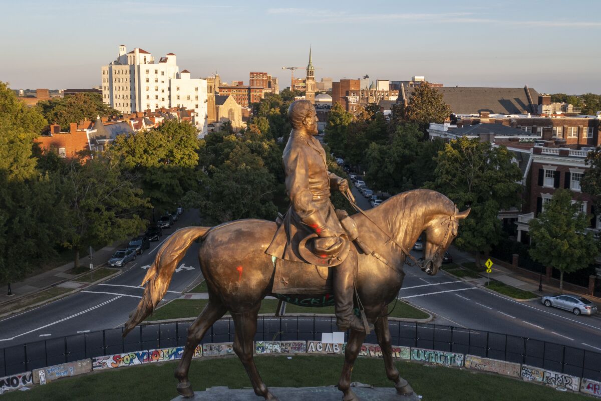 The statue of Confederate General Robert E. Lee is bathed in the late sun on Monument Avenue in Richmond, Va., Monday, Sept. 6, 2021. The statue is scheduled to be removed by the state Wednesday, Sept. 8, after a ruling by the Virginia Supreme Court. (AP Photo/Steve Helber)