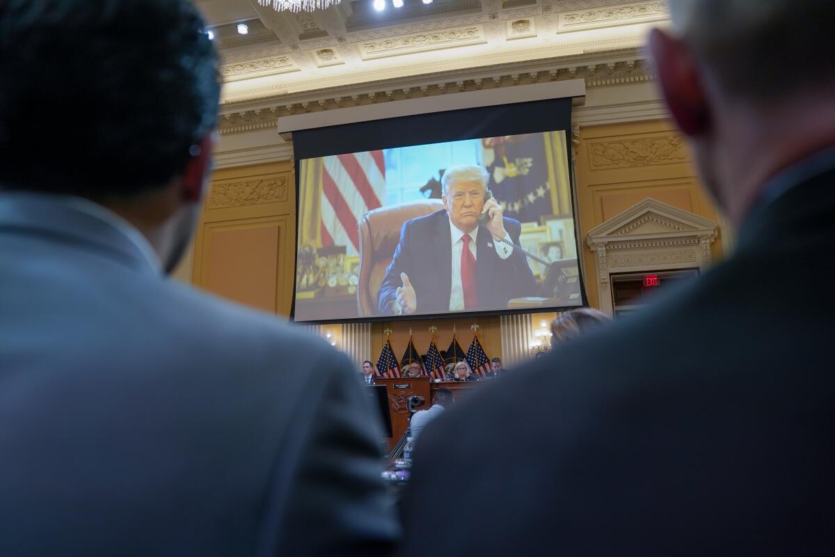 Photos of then-President Trump are shown during a House Select Committee to Investigate the January 6th hearing