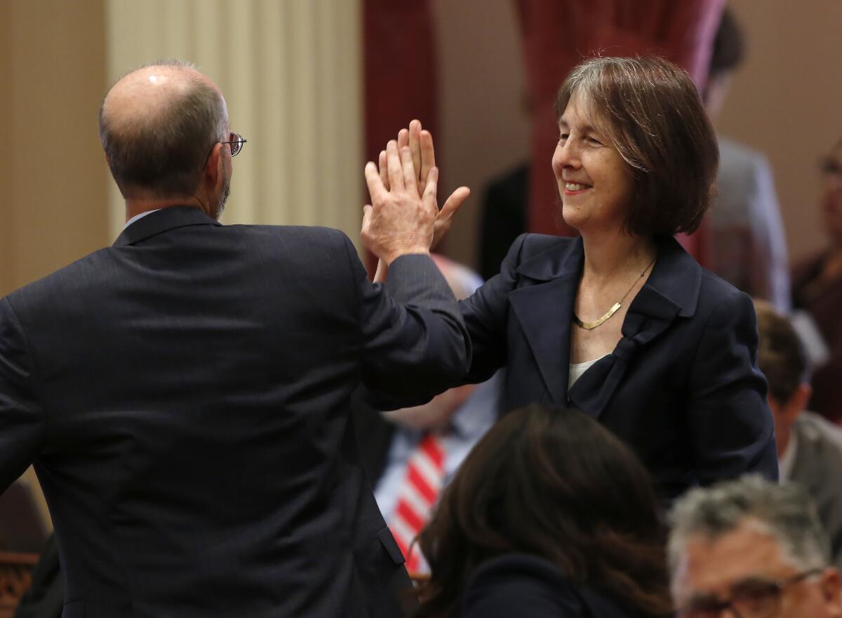 California state Sens. Nancy Skinner (D-Berkeley) and Steven Glazer (D-Orinda) slap palms.