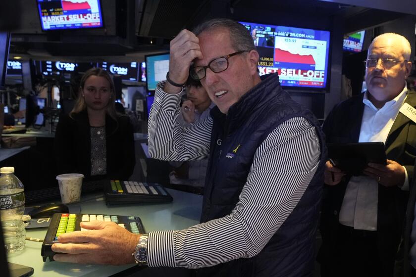 Specialist Glenn Carell works at his post on the floor of the New York Stock Exchange, Monday, Aug. 5, 2024. Nearly everything on Wall Street is tumbling as fear about a slowing U.S. economy worsens and sets off another sell-off for financial markets around the world. (AP Photo/Richard Drew)