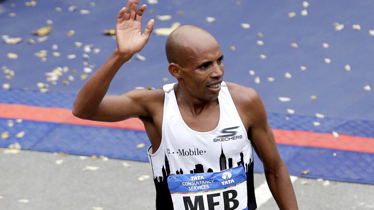 Meb Keflezighi acknowledges fans after he crosses the finish line at the New York City Marathon in November.