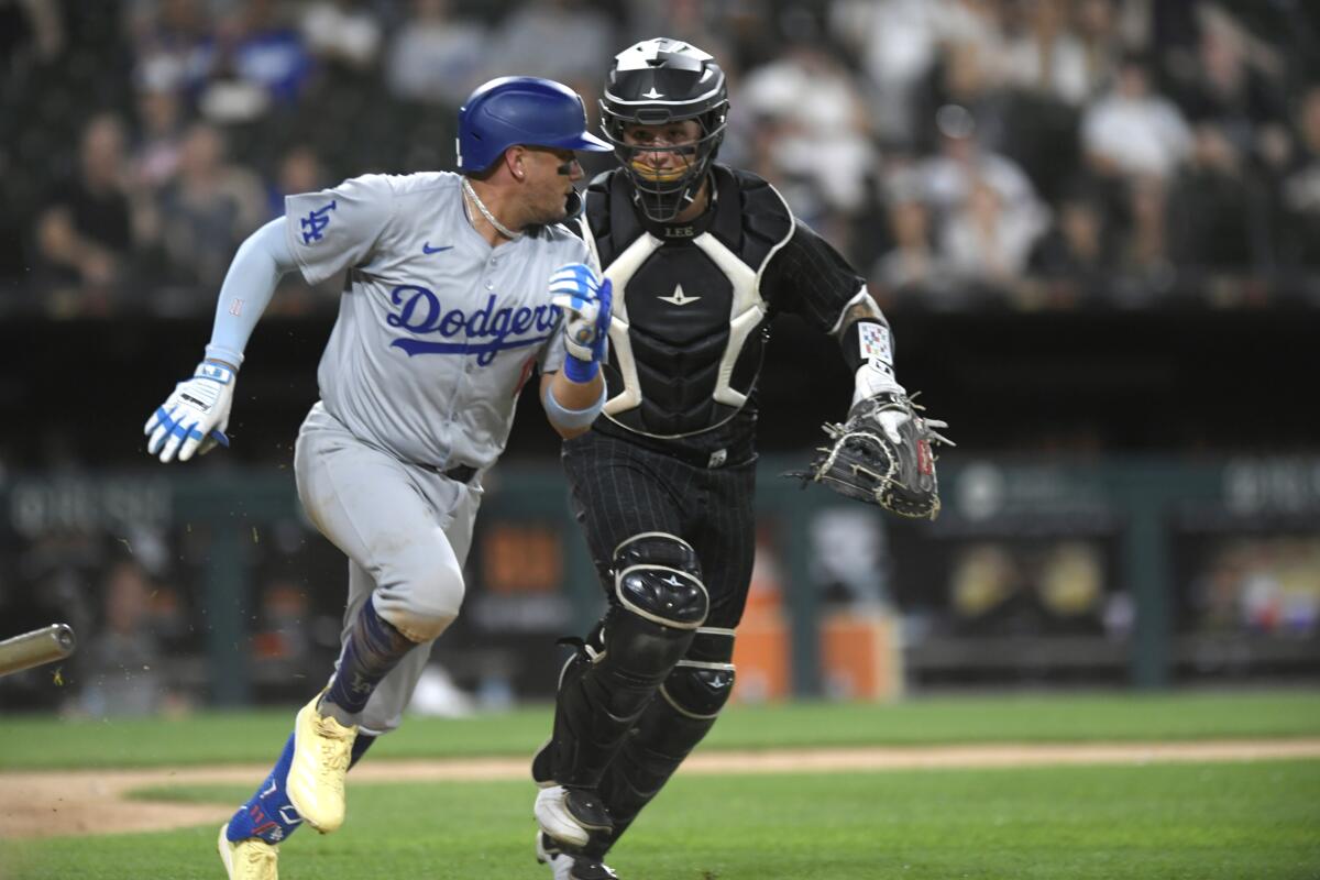 Dodgers batter Miguel Rojas is tagged out by Chicago White Sox catcher Korey Lee during the eighth inning.