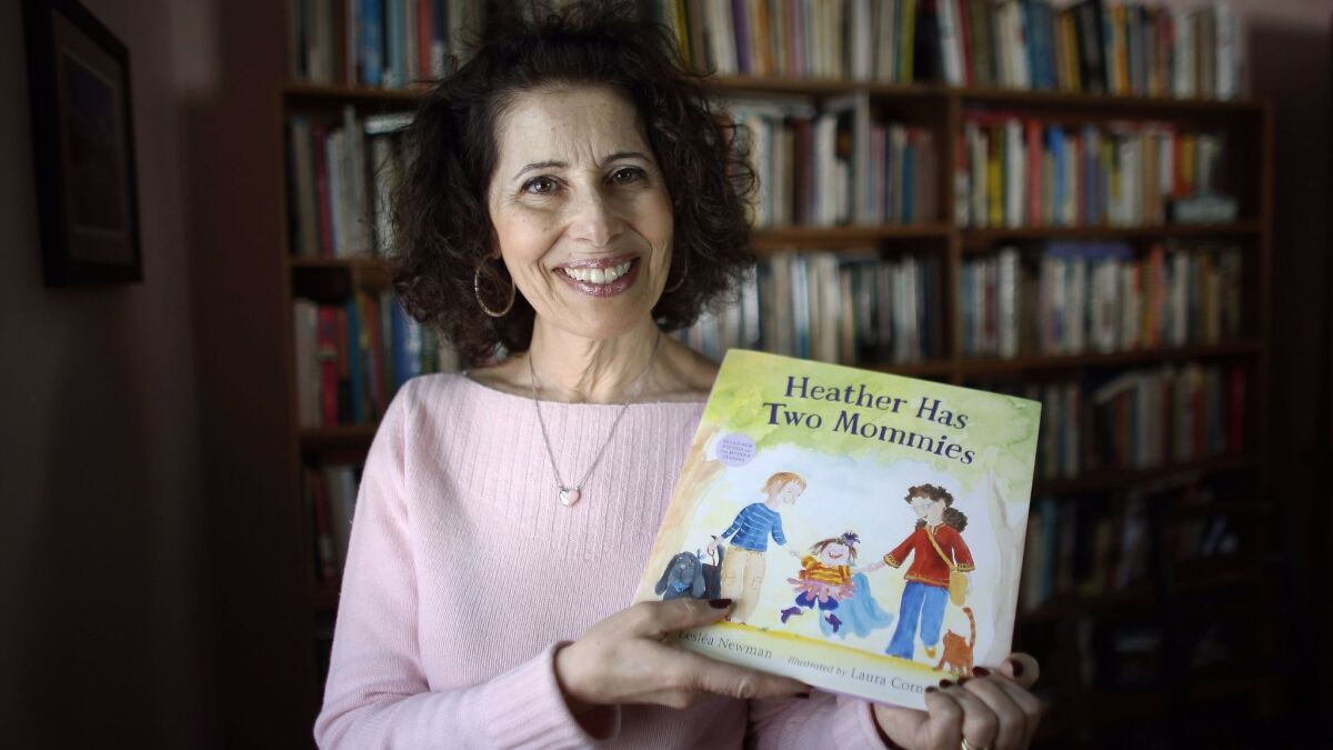 Leslea Newman with her children's book "Heather Has Two Mommies."
