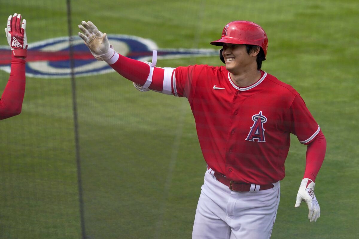 Shohei Ohtani celebrates after hitting a solo home run against the Cincinnati Reds on March 15.