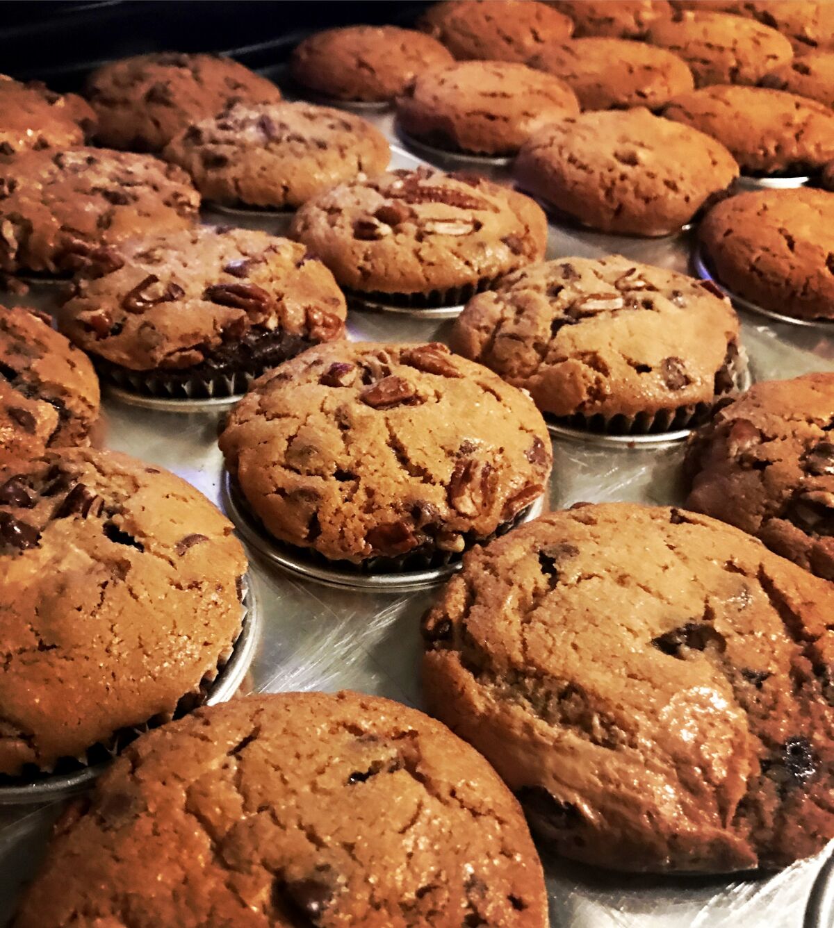 Milk + Brookies cross between brownies and cookies are baked in cupcake tins.
