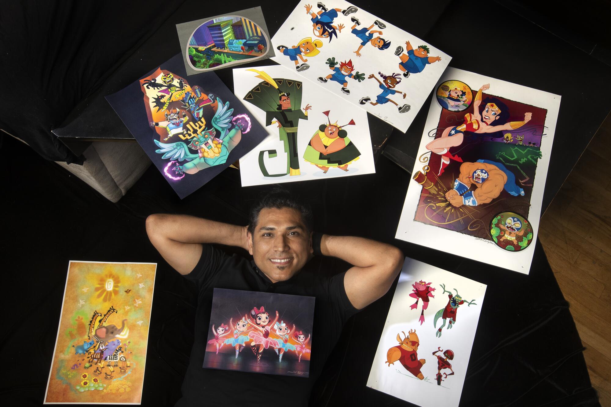 Artist Jose Zelaya is photographed next to some of his portfolio pieces at his home in Burbank. Zelaya.