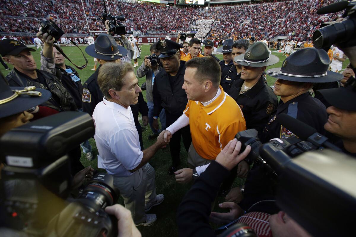 Tennessee Coach Butch Jones, right, congratulates Alabama Coach Nick Saban after their game on Oct. 26, 2013. The two face off in a top 10 matchup on Saturday.