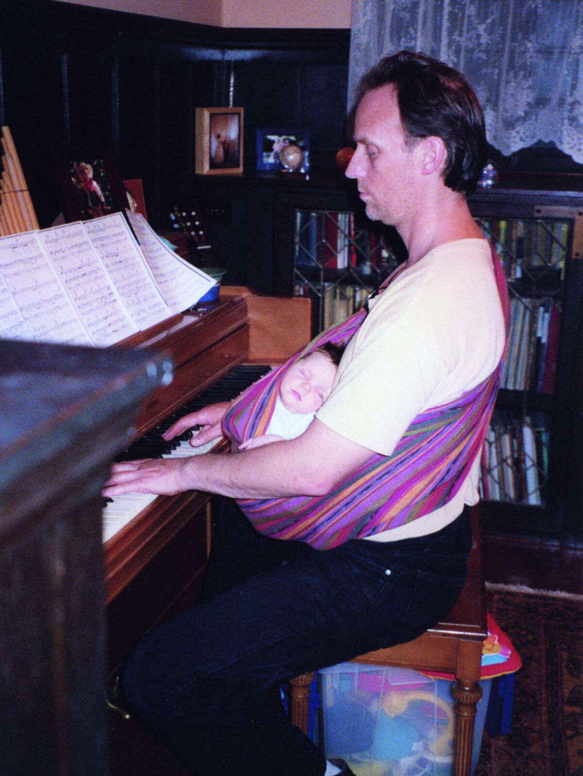 A man and baby at a piano