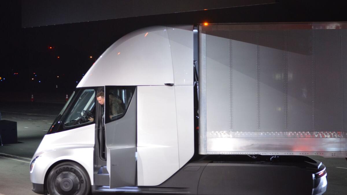 Tesla Chairman and CEO Elon Musk steps out of the new "Semi" electric Truck during the unveiling in Hawthorne.
