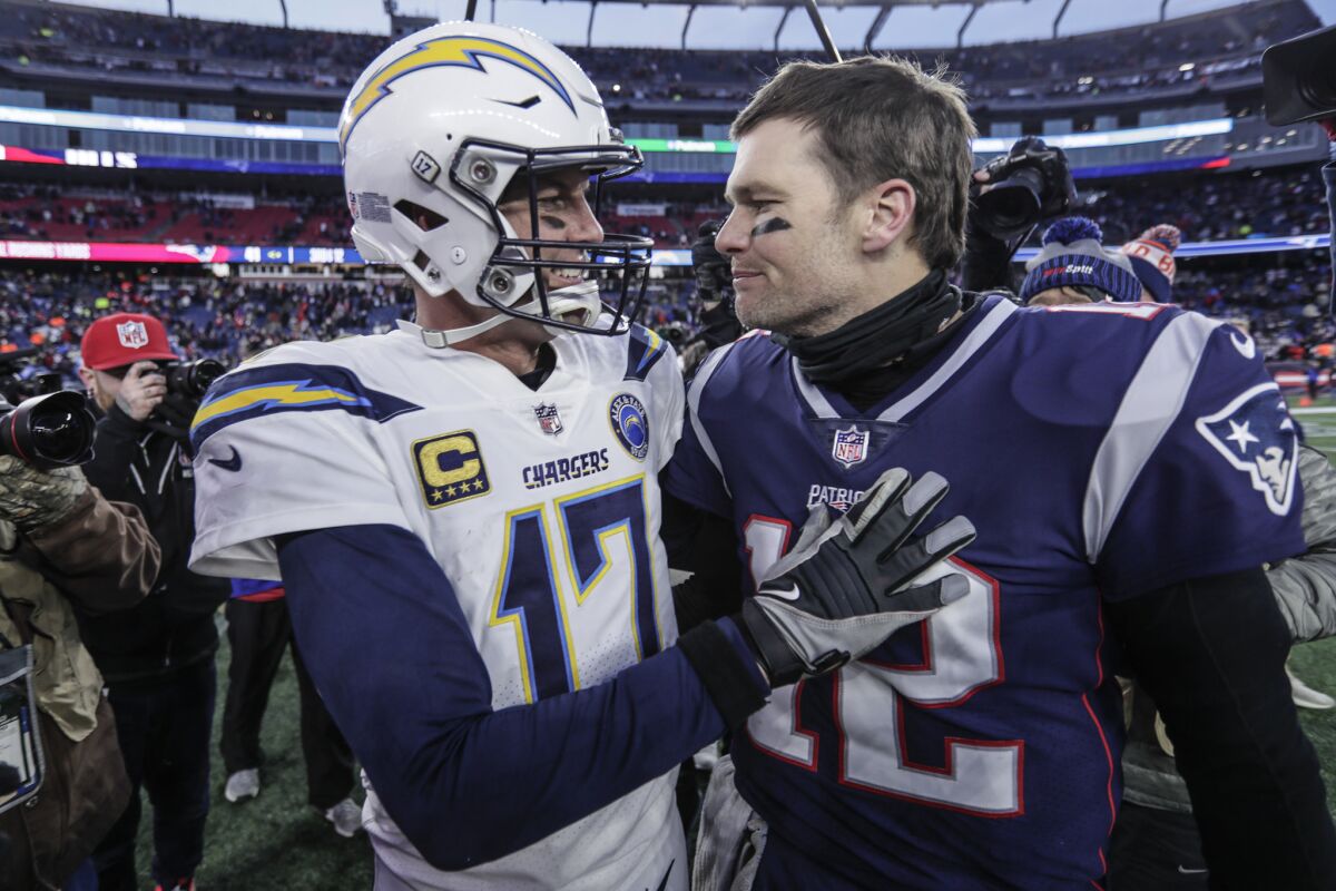 Chargers quarterback Philip Rivers talks to Patriots quarterback Tom Brady after the game.
