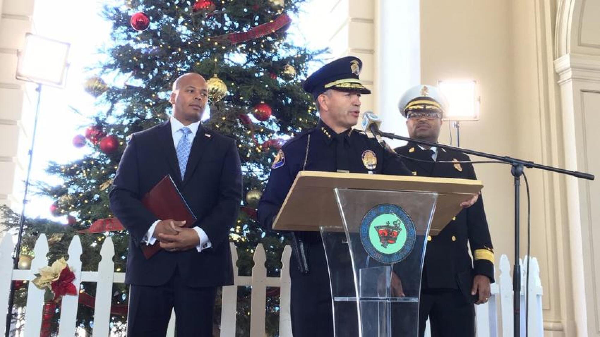 Pasadena Police Chief Phillip Sanchez, flanked by two men.