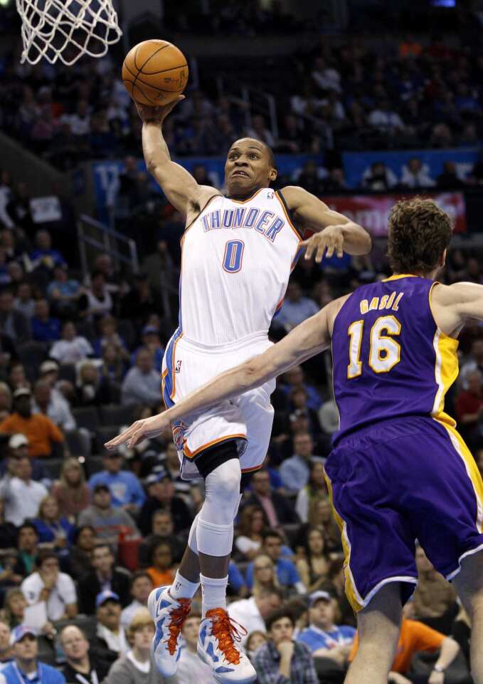 Thunder guard Russell Westbrook elevates for a dunk over Lakers power forward Pau Gasol in the second half Thursday night in Oklahoma City.