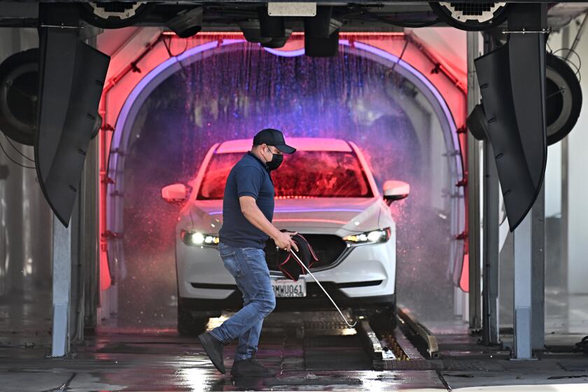 Anaheim, California May 1, 2022-An employee at the Torrance Car Wash does maintenance at the business which was cited for $815,311 for wage theft violations involving 35 workers, (Wally Skalij/Los Angeles Times)