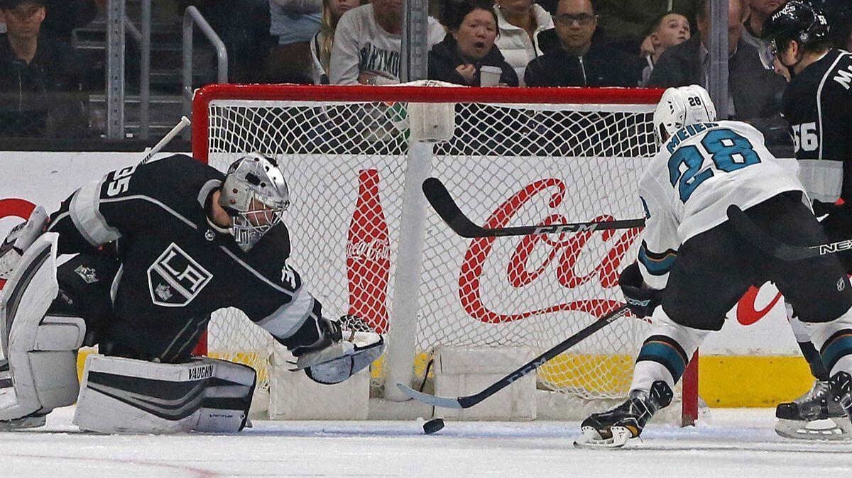 Kings goalie Darcy Kuemper (35) stops a shot by San Jose Sharks right winger Timo Meier (28) in the second period Monday.