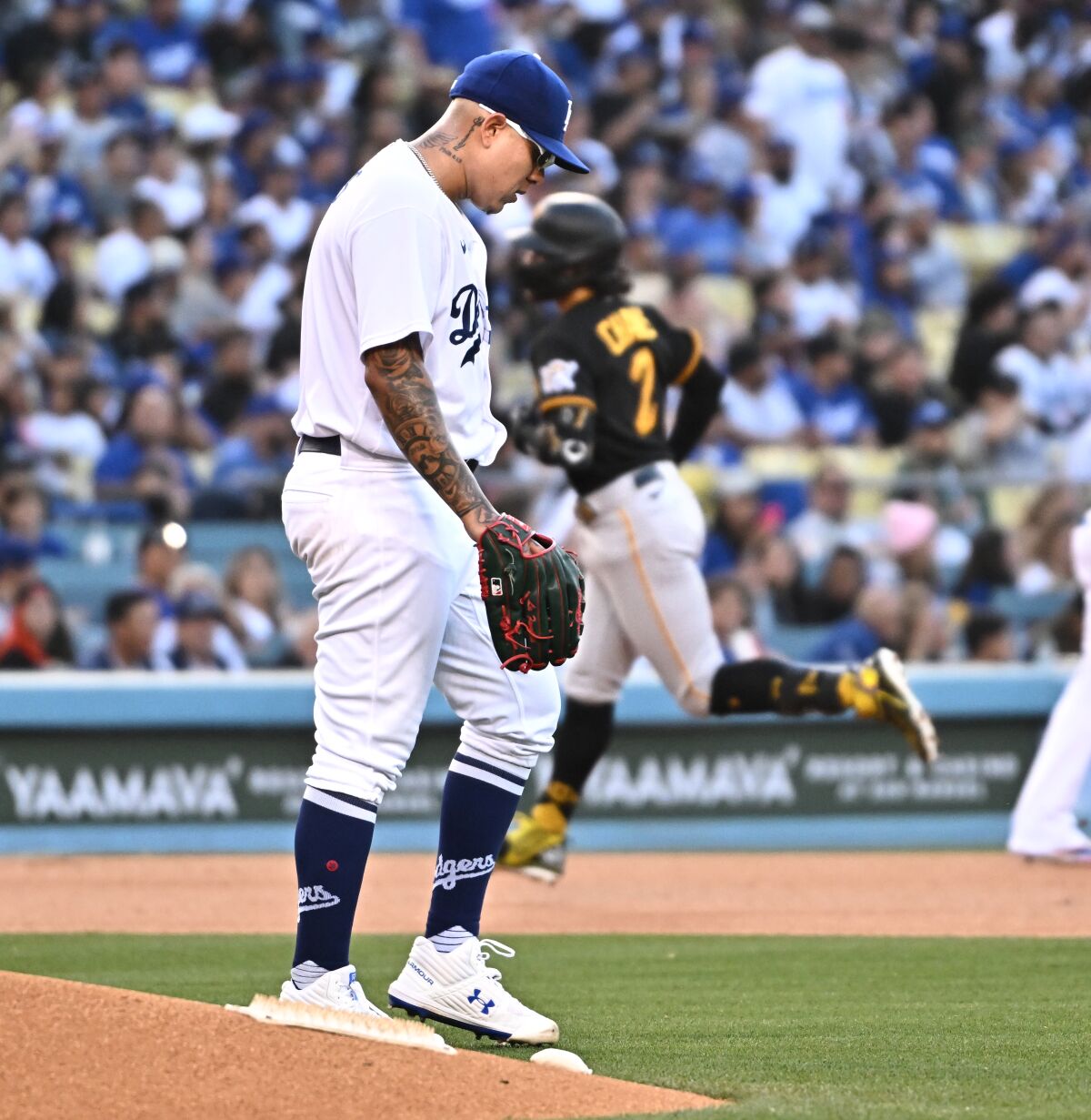 Dodgers pitcher Julio Urías walks back to the mound after giving up a two-run home run.