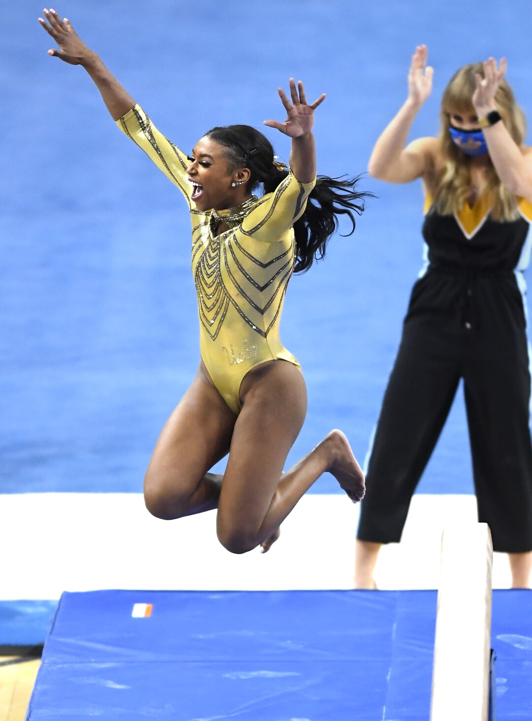 UCLA's Nia Dennis celebrates after competing on the beam during Wednesday's meet against Brigham Young.