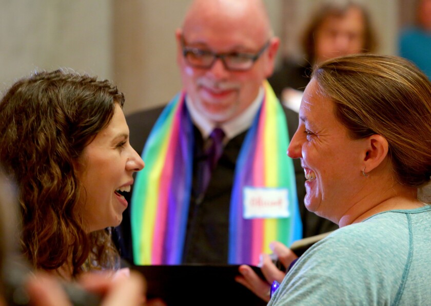 Andria Stock, left, and Chantel Jandak of Jacksonport are married Monday by Joey Cole in Little Rock, Ark.