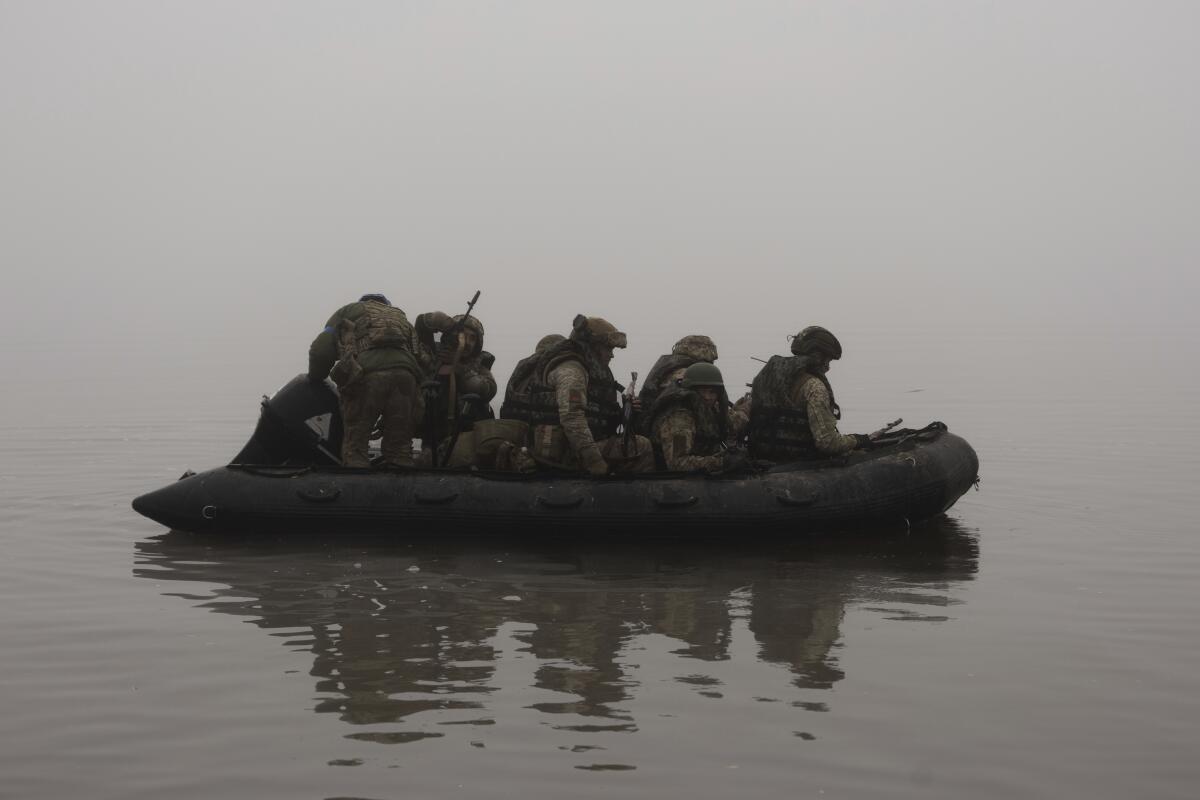 Ukrainian marines on a boat along the Dnipro River