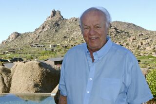 FILE - T. Denny Sanford, a retired banking executive turned philanthropist, poses for a photo on the patio of his home overlooking Pinnacle Peak in Scottsdale, Ariz., March 24, 2016. The South Dakota attorney general's office has declined to file charges against Sanford following an investigation into possible possession of child pornography, saying it found no “prosecutable offenses” within the state's jurisdiction, according to a court document filed Friday, May 27, 2022. (AP Photo/Dirk Lammers, File)