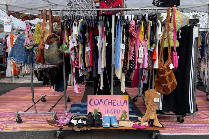 A clothing rack at an outdoor flea market 
