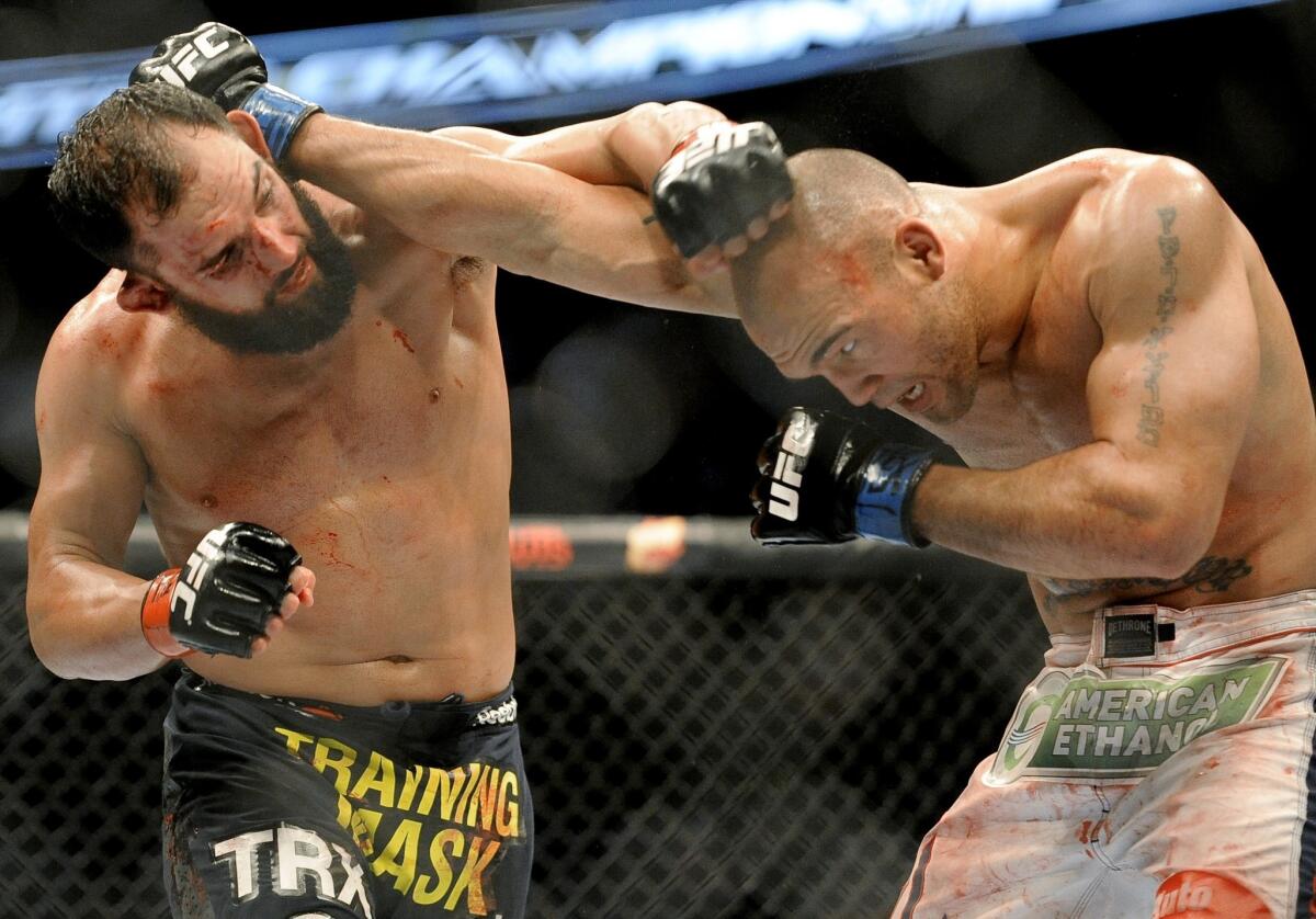 Johny Hendricks, left, won the UFC welterweight title with his unanimous decision over Robbie Lawler on Saturday night.