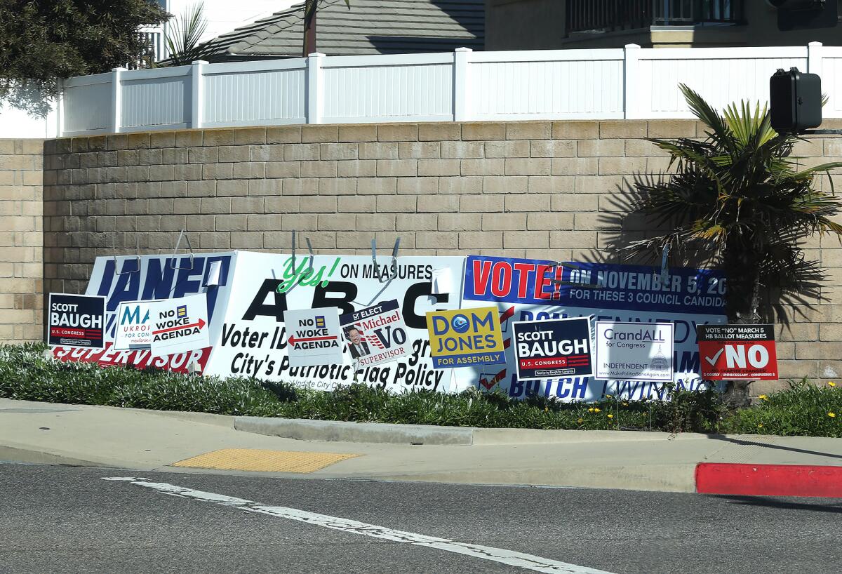 Political signs on street corners in Huntington Beach on Wednesday.