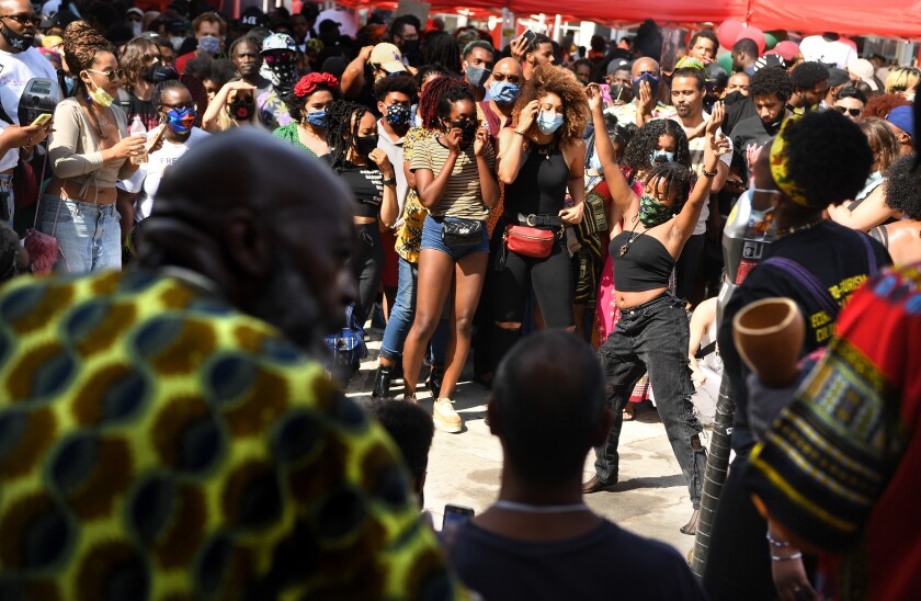 A woman dances during a Juneteenth celebration in Leimert Park.